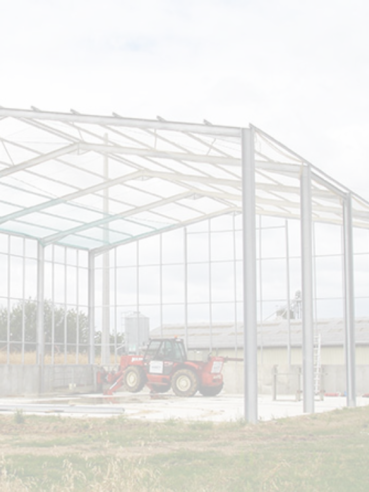 hangar métallique en construction Soulie CEA avec tracteur rouge sur dalle béton à Lédergues,